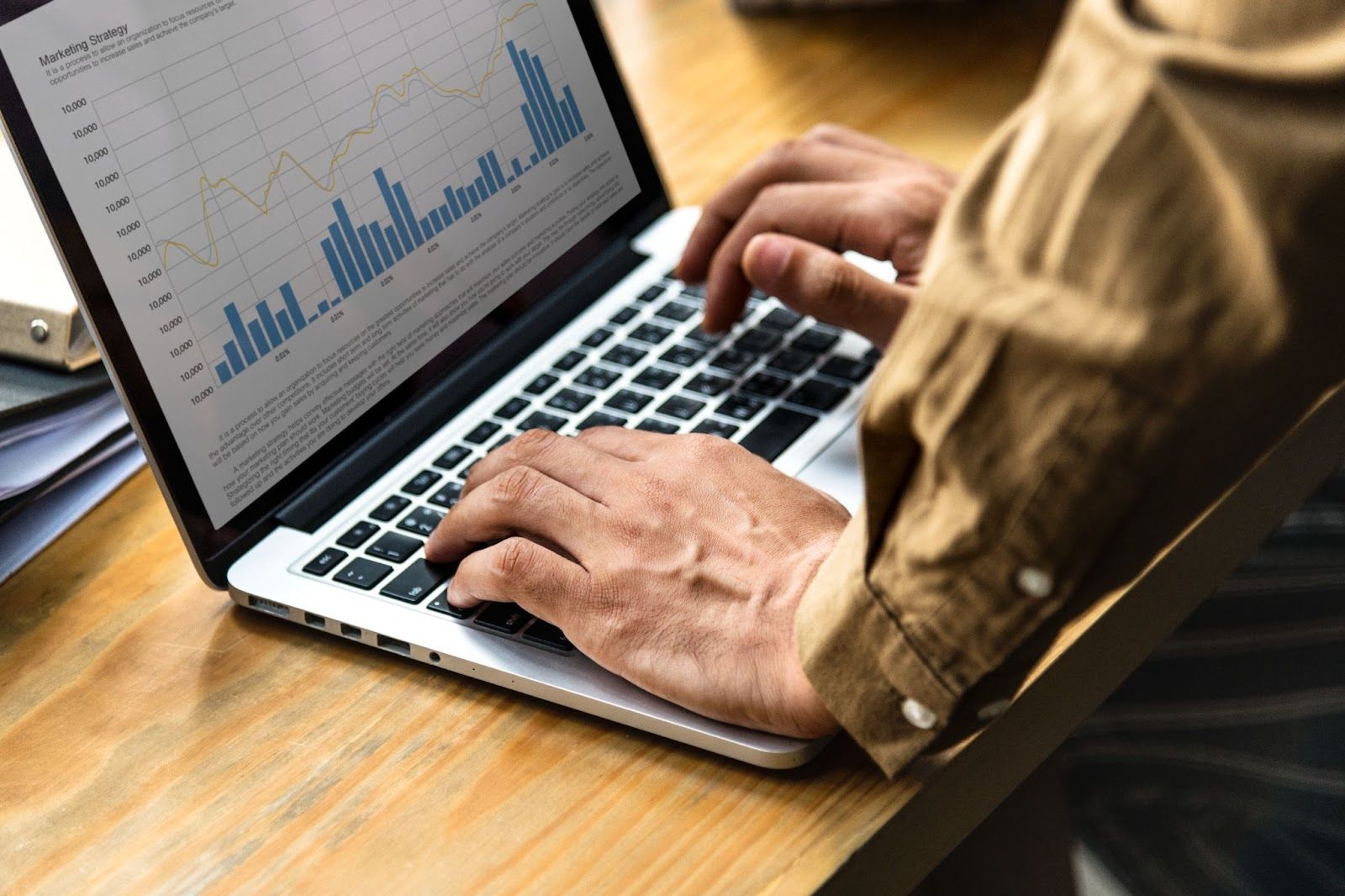 man looking at website tracking data on a laptop