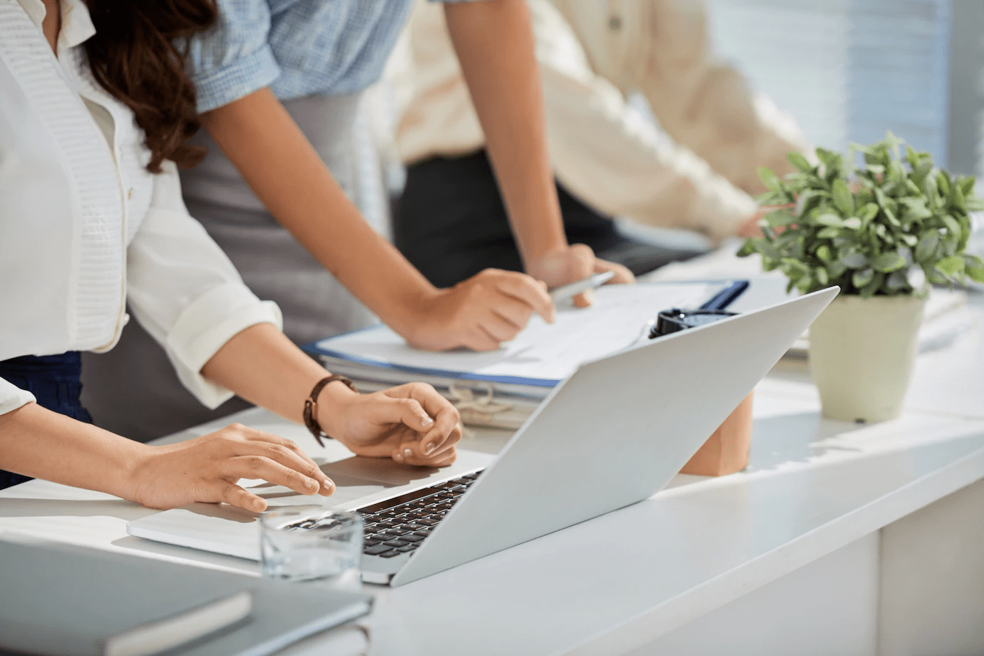 people sitting at a desk and a laptop