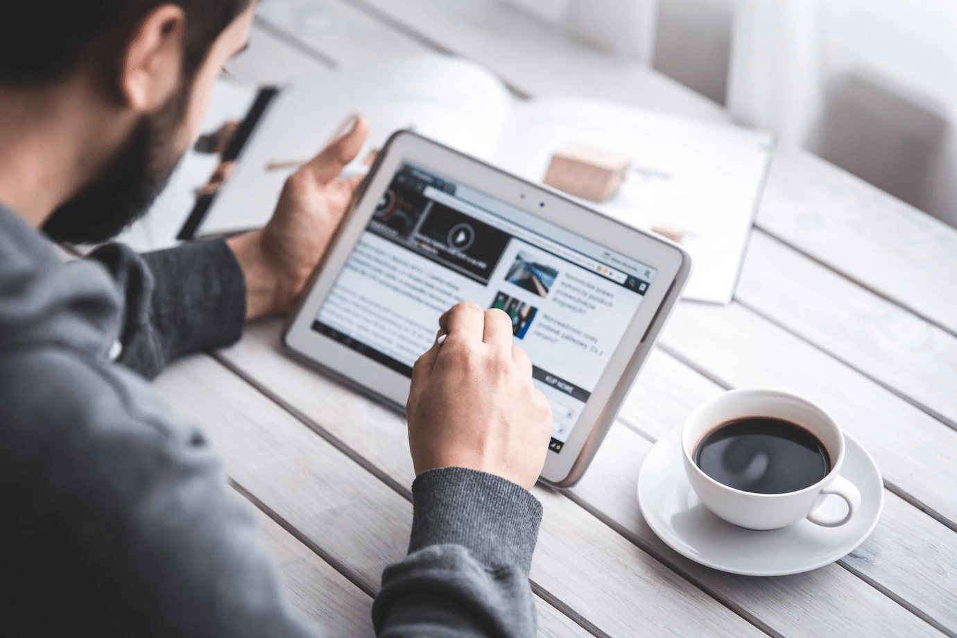 man looking at a website on a tablet