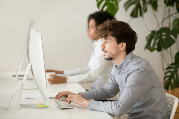 two people looking at two computers