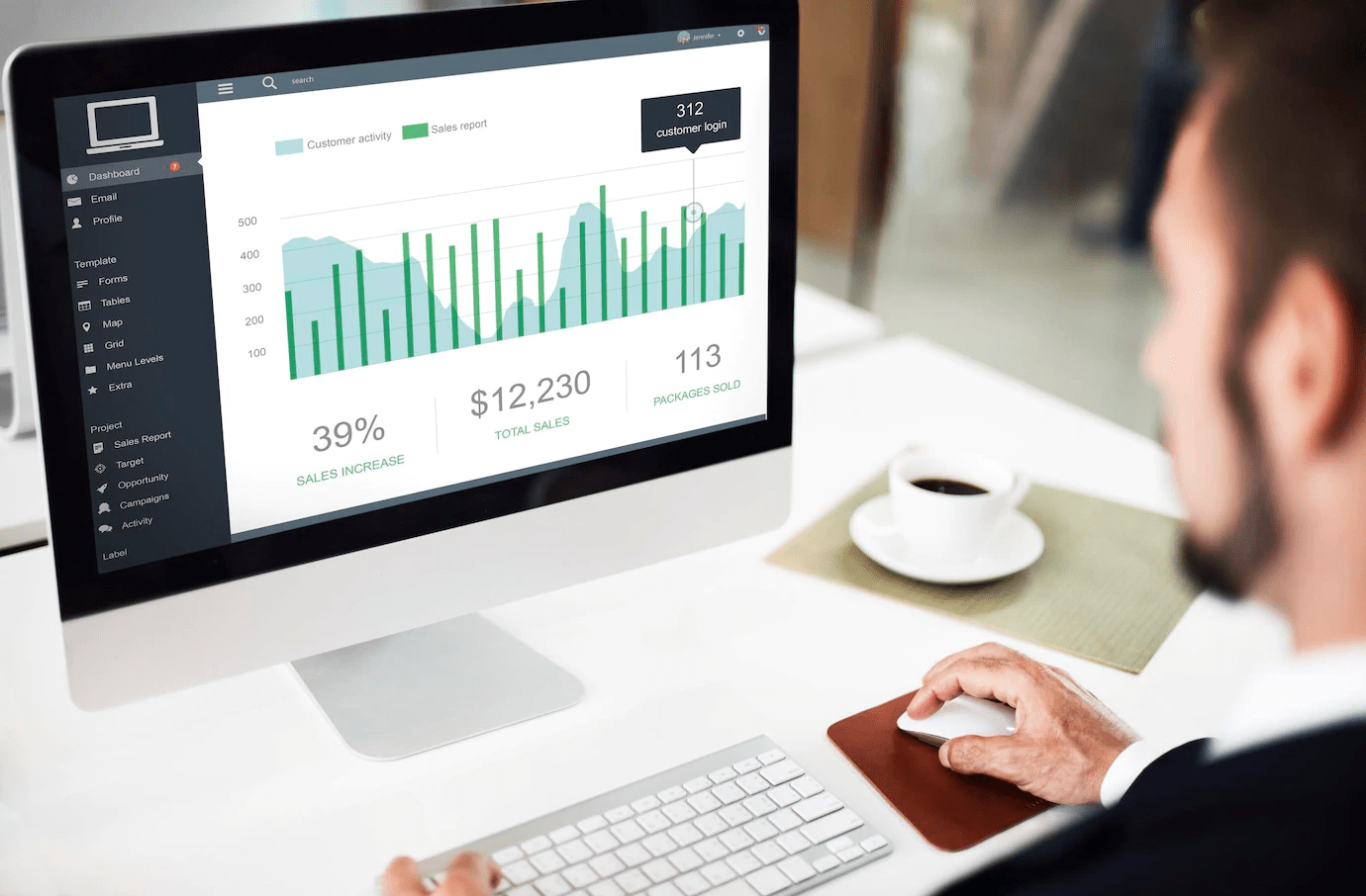 man looking at charts on a screen