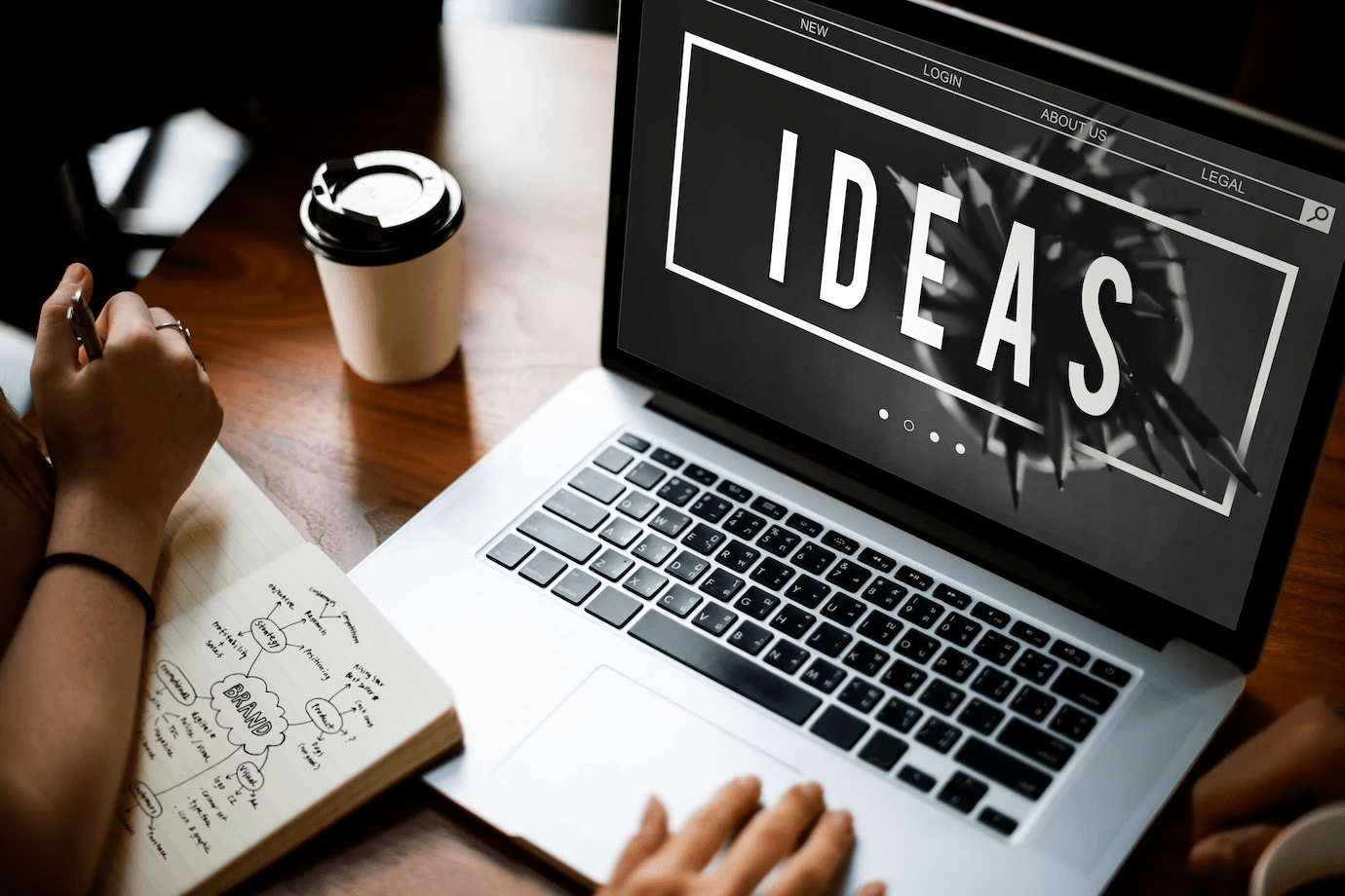 two people looking at ideas logo on a laptop