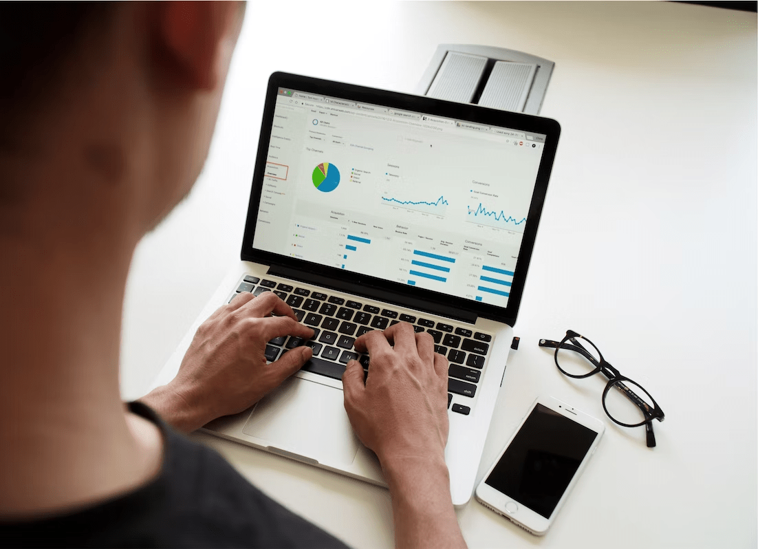 man looking at statistics on a laptop