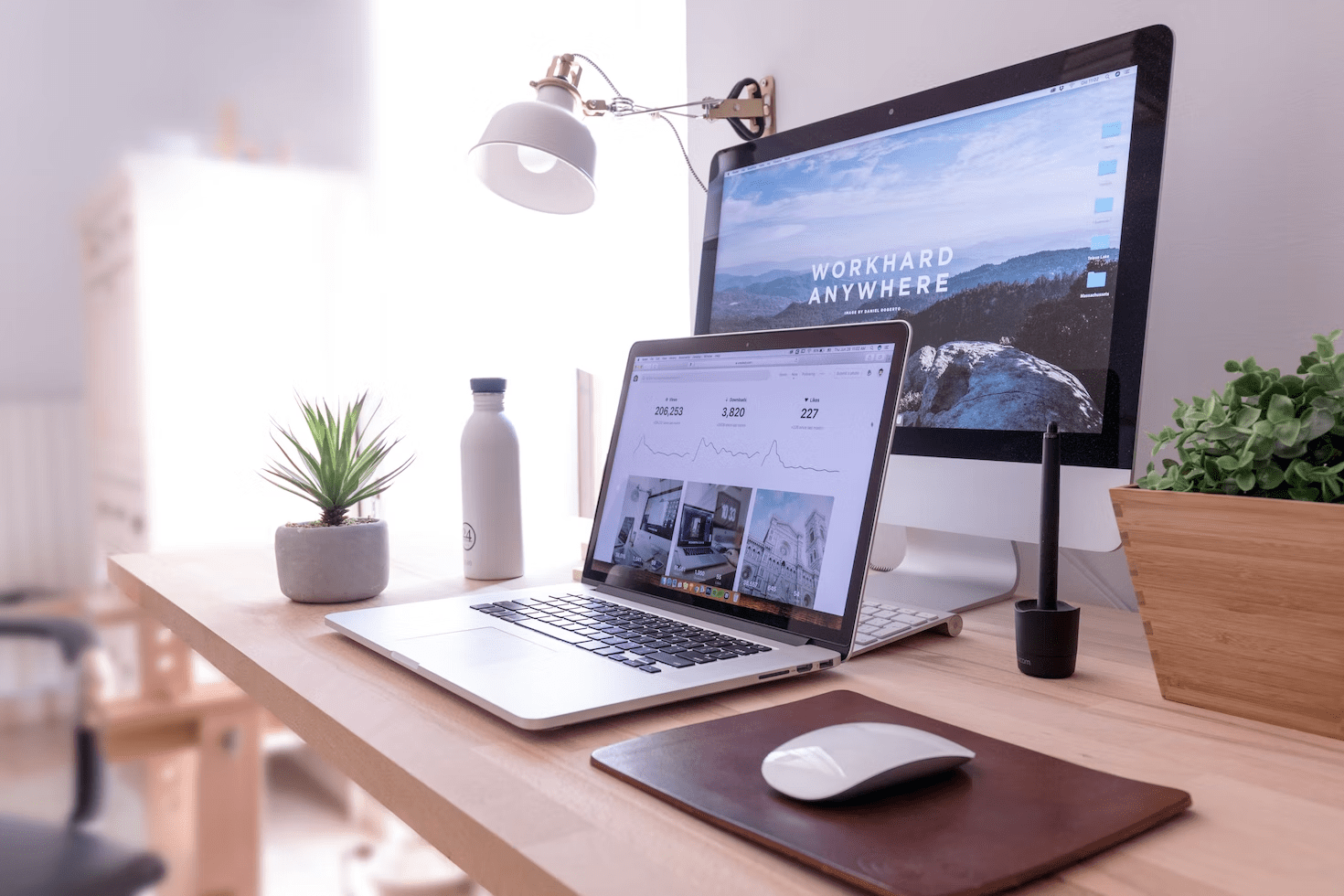 a laptop and a pc on a desk