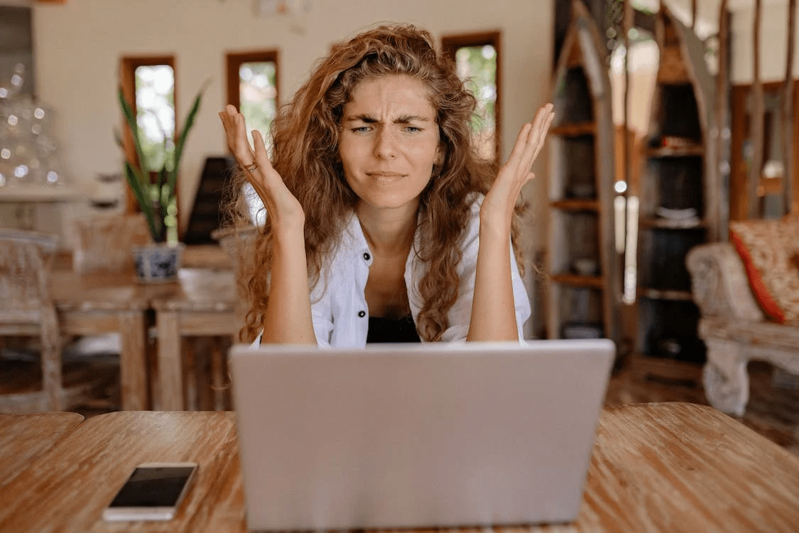 frustrated woman looking at a laptop
