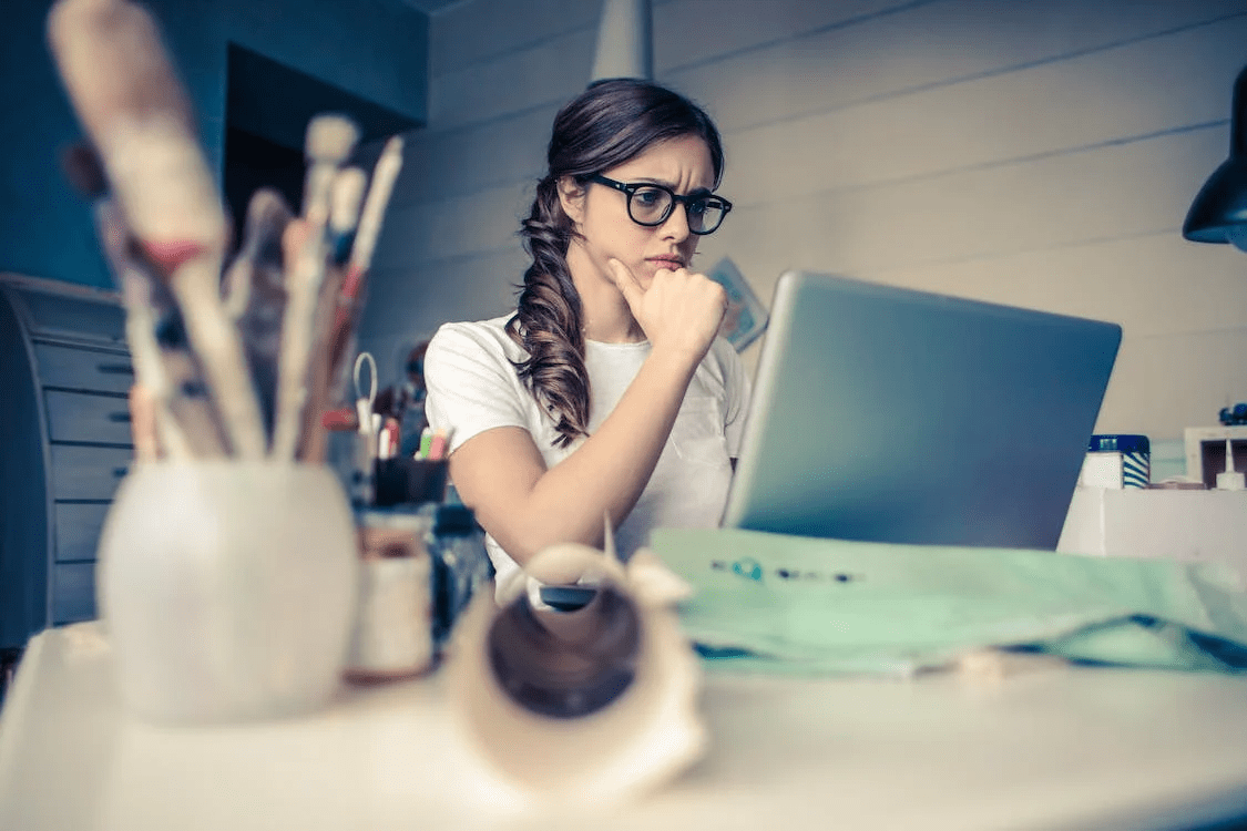 worried woman looking at her laptop
