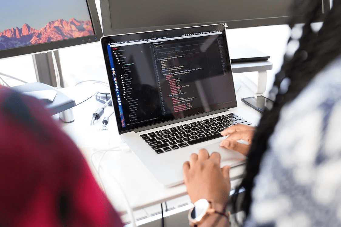 woman coding on a laptop