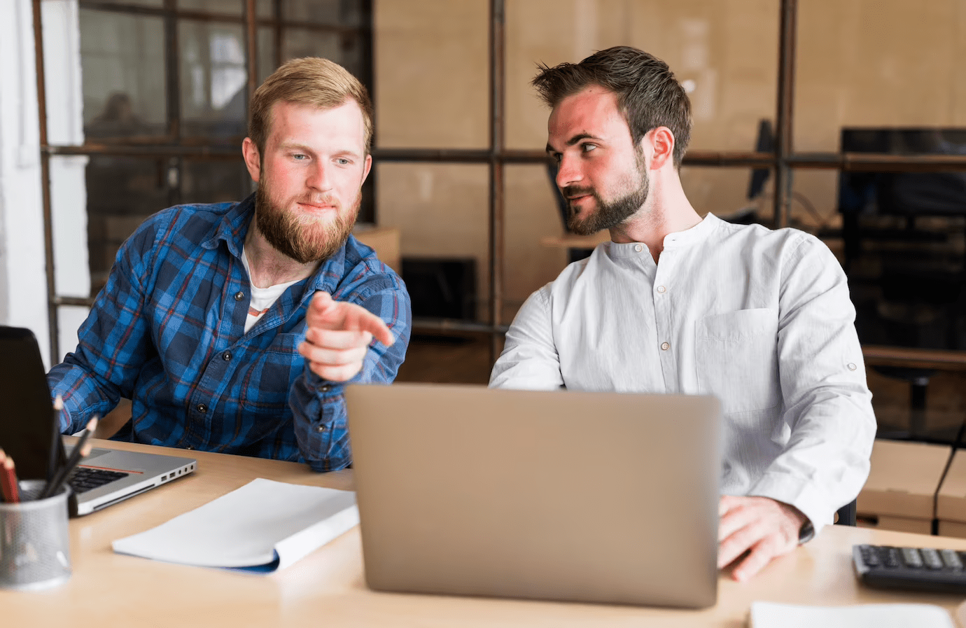 two man looking at a laptop