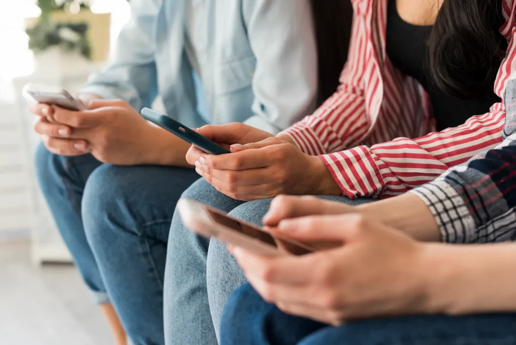 Photo of several people sitting and using smartphones under the heading “Why is Mobile Analytics Important?