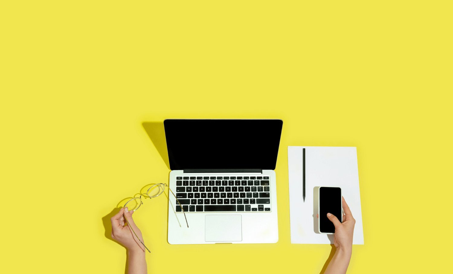 a person using a laptop and a phone