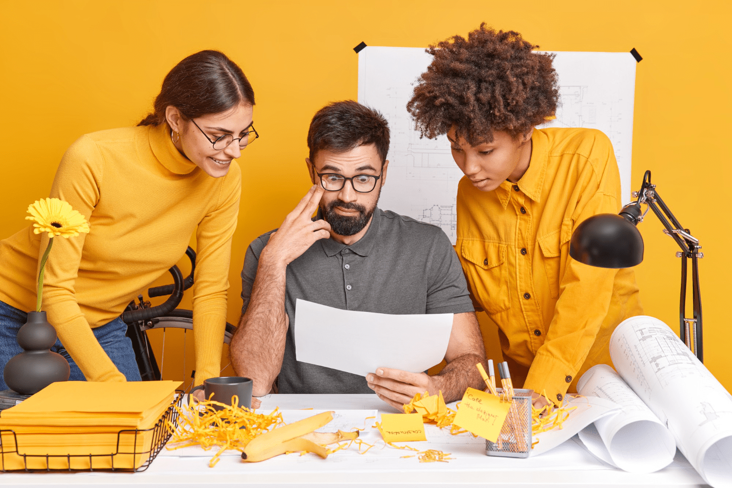 a group of people looking at a piece of paper