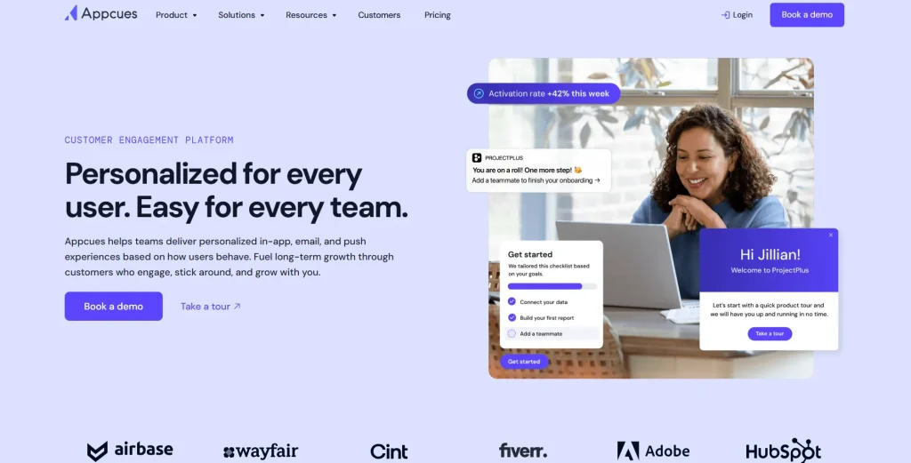 Appcues homepage showing its customer engagement platform with in-app onboarding messages, product tour prompts, checklist widgets, and brand logos including Adobe, HubSpot, Fiverr, Wayfair, and Airbase.